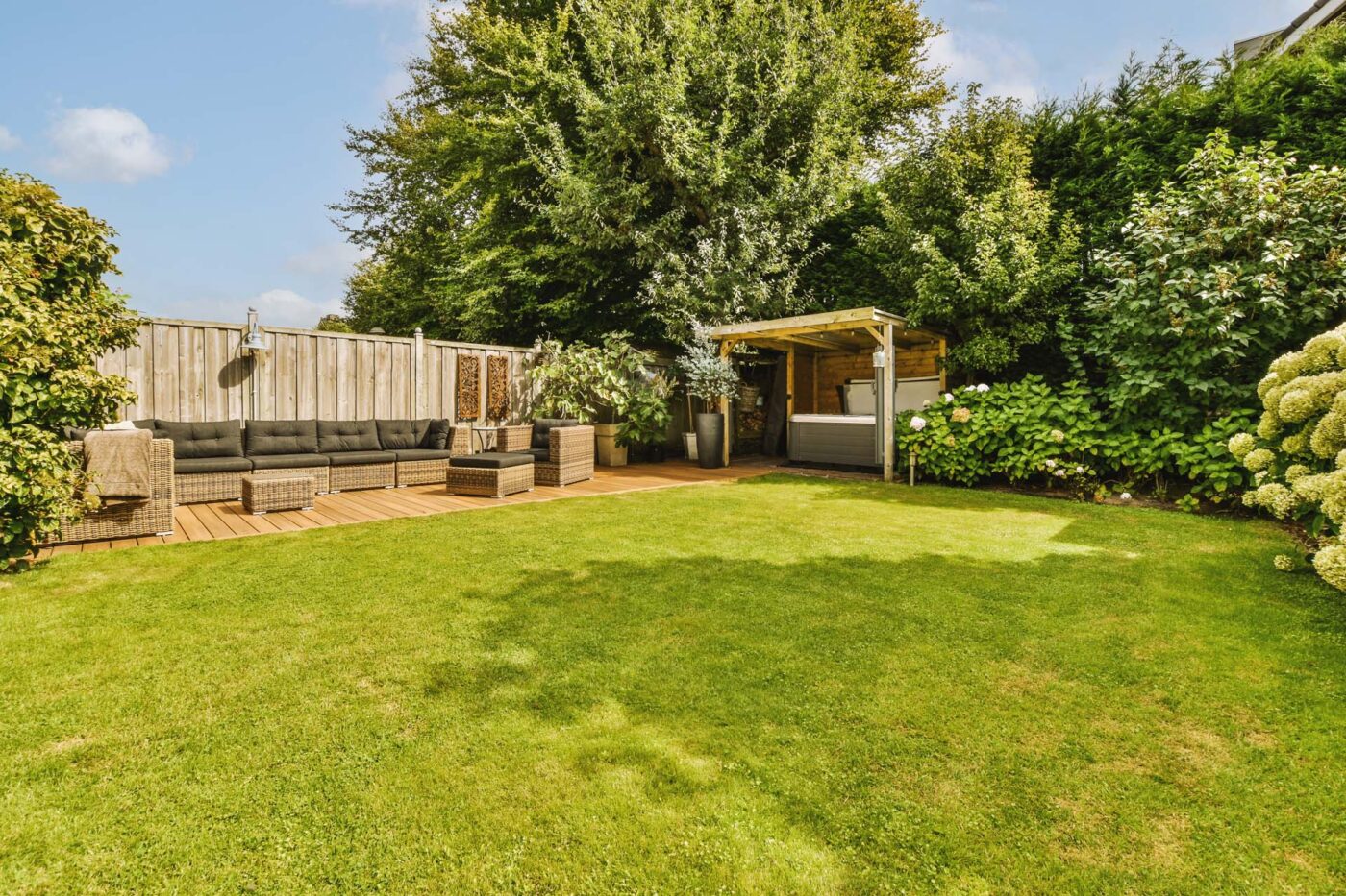 Water and Flame Neat paved patio with sitting area and small garden near wooden fence