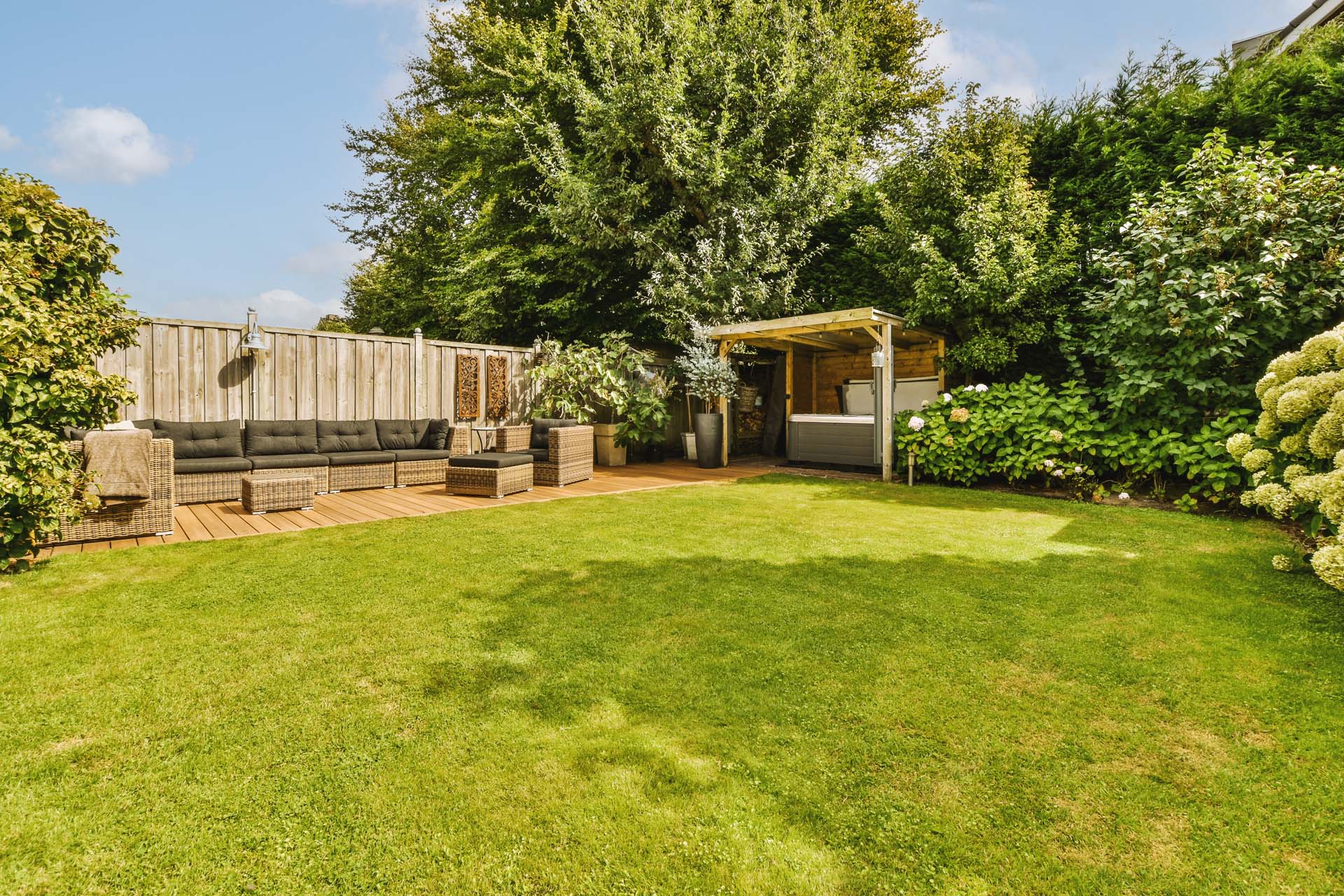 Water and Flame Neat paved patio with sitting area and small garden near wooden fence