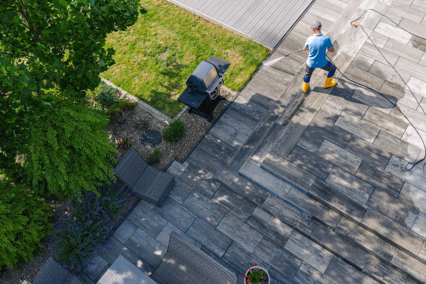 Water and Flame person using a pressure washer to clean the garden
